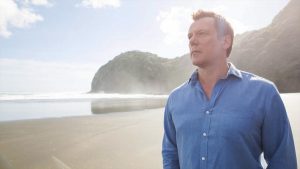 man on beach looking into the distance