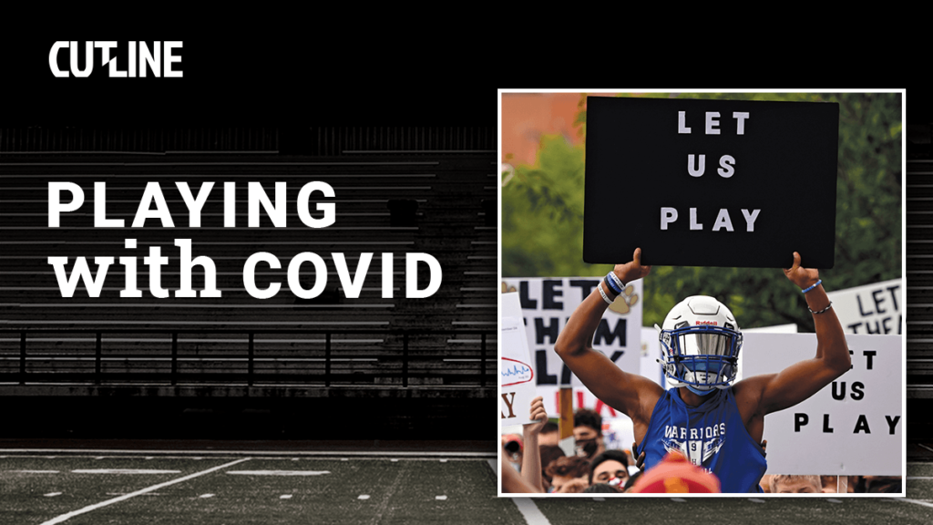 football player holding "Let Us Play" sign